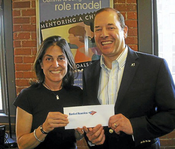 Two people holding a Bank of America envelope.