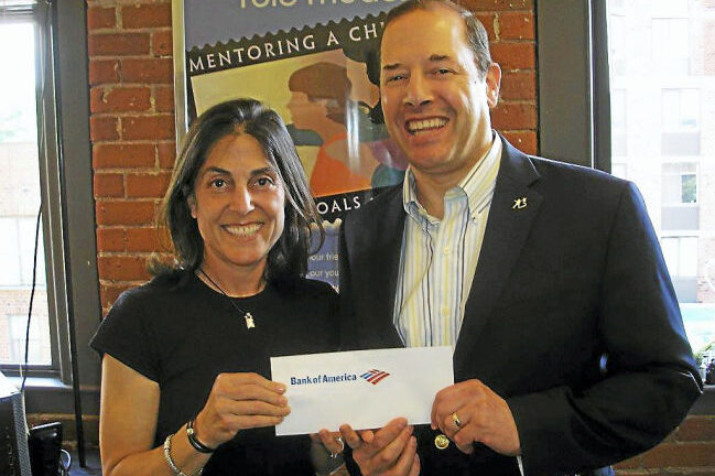 Two people holding a Bank of America envelope.
