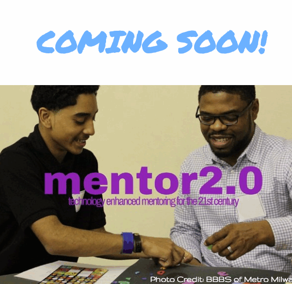 Two men using a tablet together, smiling.