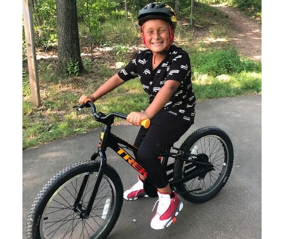 Little Brother Ocean sitting on his new BMX bike