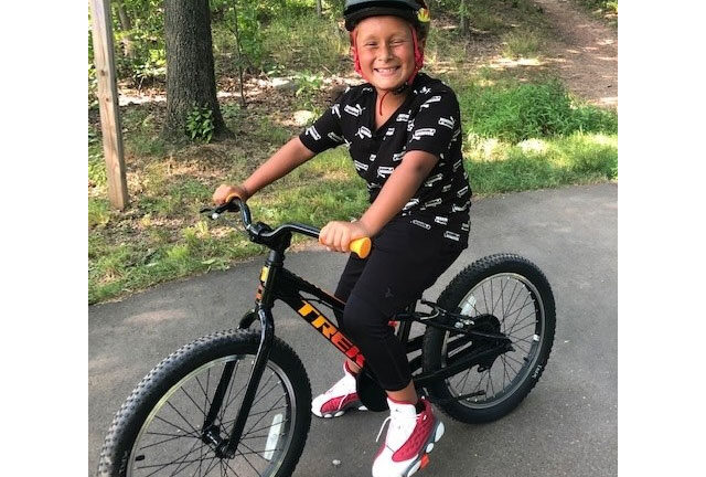 Little Brother Ocean sitting on his new BMX bike