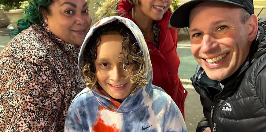 Background: Janette Mojica, Mother of Little Brother Ocean; Julia Vazquez, Grandmother of Little Brother Ocean. Foreground: Little Brother Ocean; Big Brother Joe DeLutrie