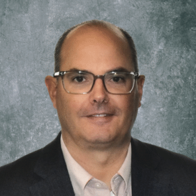 Professional man wearing glasses and a suit jacket.